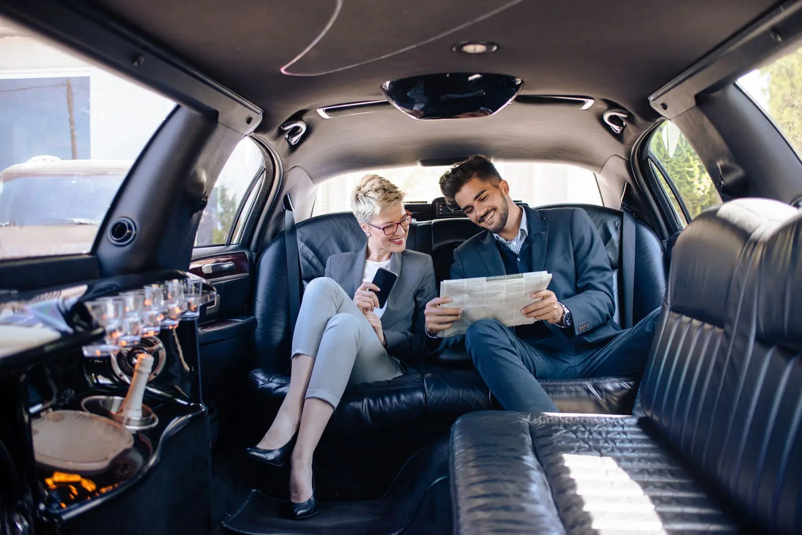 Passengers relaxing in a luxury limousine interior on a long-distance trip from Chicago