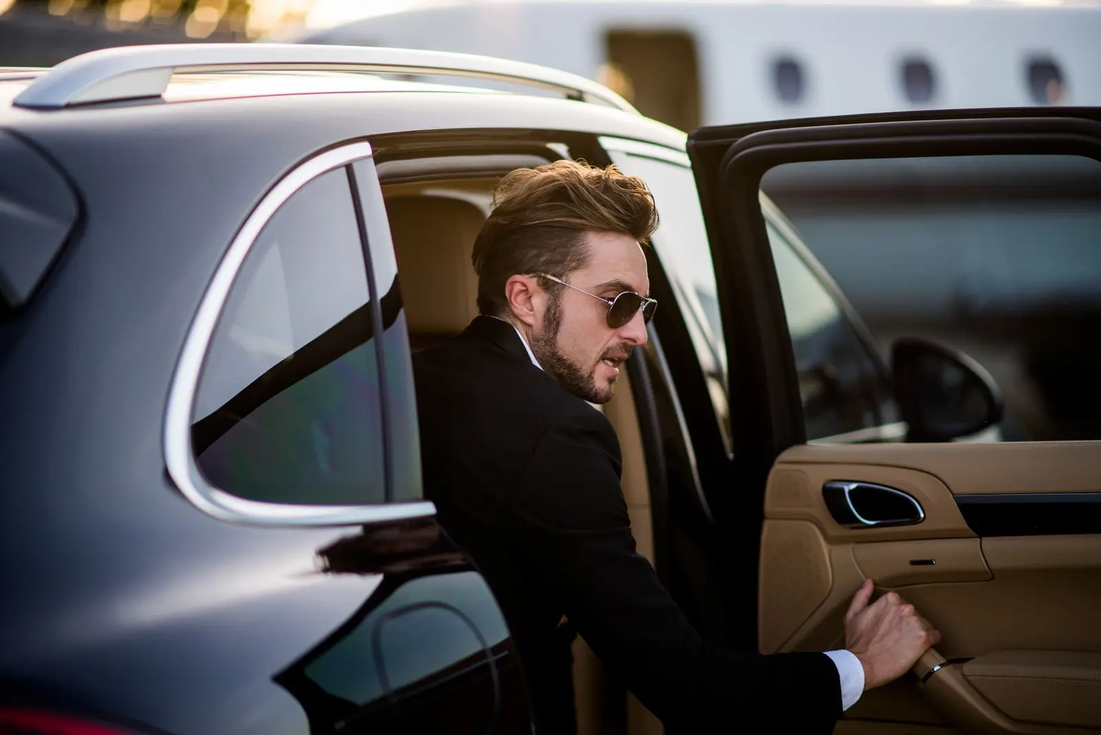 Executive stepping from a black luxury SUV for a Midway airport transfer in Chicago